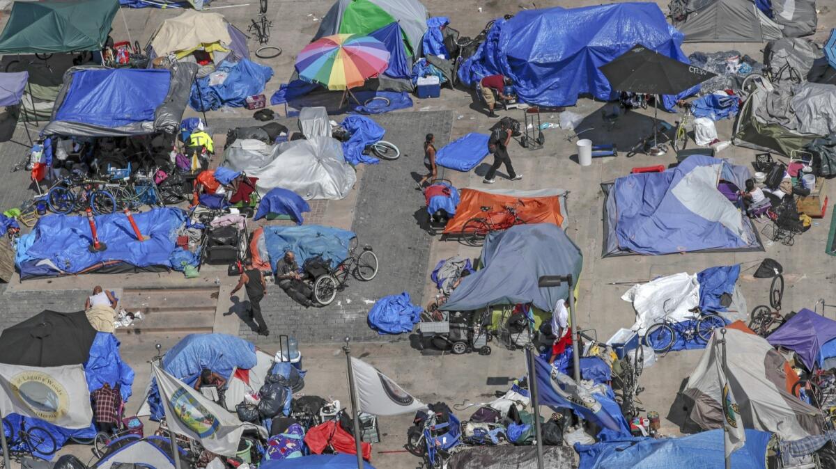 Law enforcement officials have begun clearing transient camps in the Santa Ana Civic Center's Plaza of the Flags area next to Orange County Superior Court.
