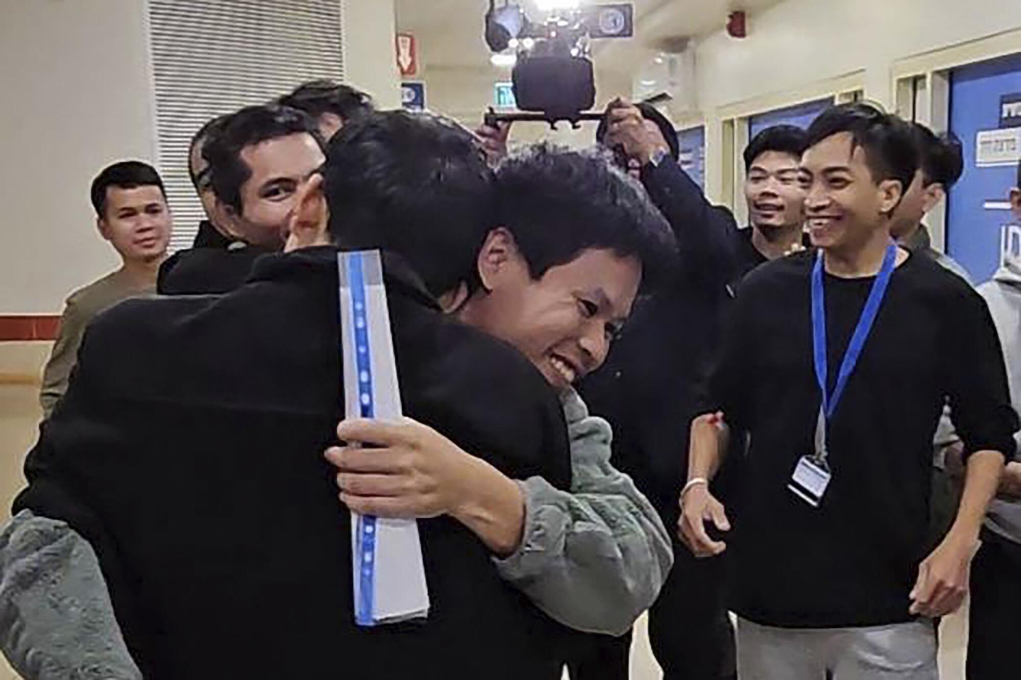 Thai workers newly released from captivity in Gaza being greeted by fellow workers