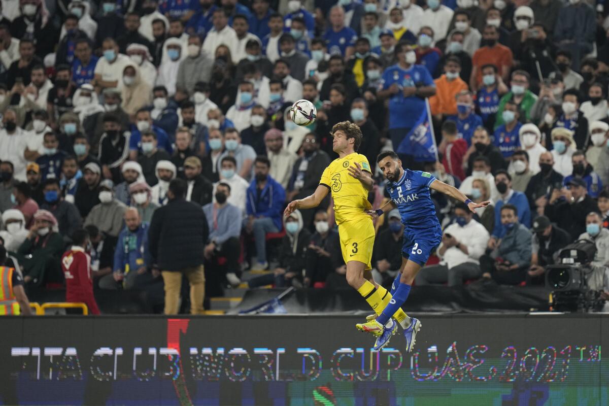 Chelsea's Marcos Alonso, left, and Al Hilal's Mohammed Al Burayk jump 