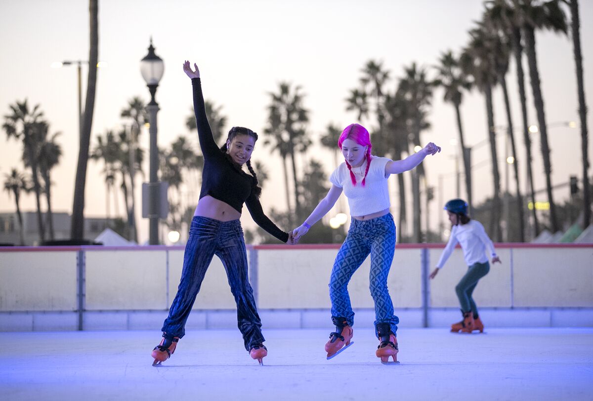  Ava Otto, left, and Kiya Barczyszyn try out their skills at the Surf City Winter Wonderland ice rink.