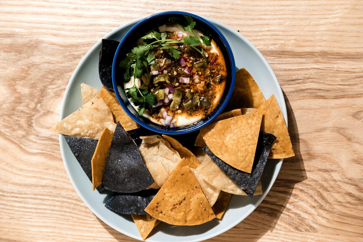 White queso with poblano peppers, corn, red onion, cilantro and chips from All Day Baby, now open in Silver Lake.