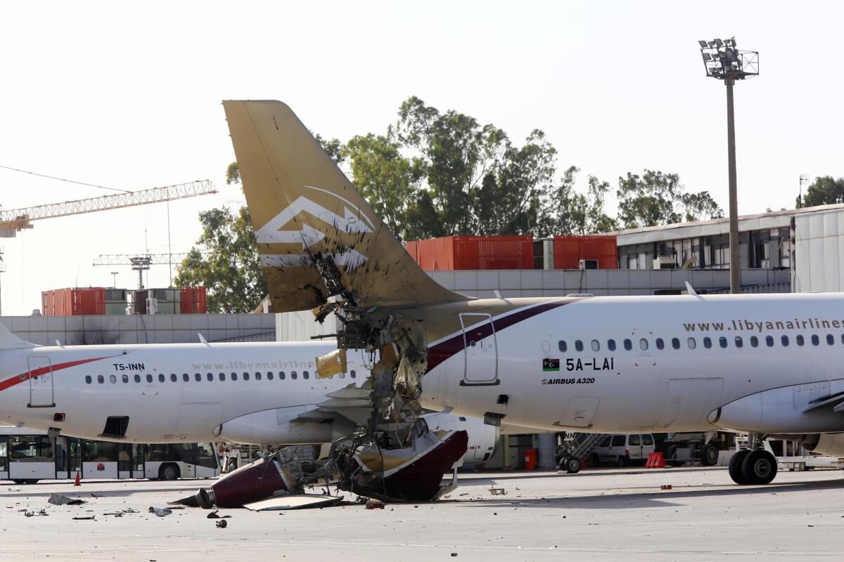 Damaged civilian airplanes sit on the tarmac at the international airport in Tripoli, Libya, after a firefight in August. The airport has been closed since July.