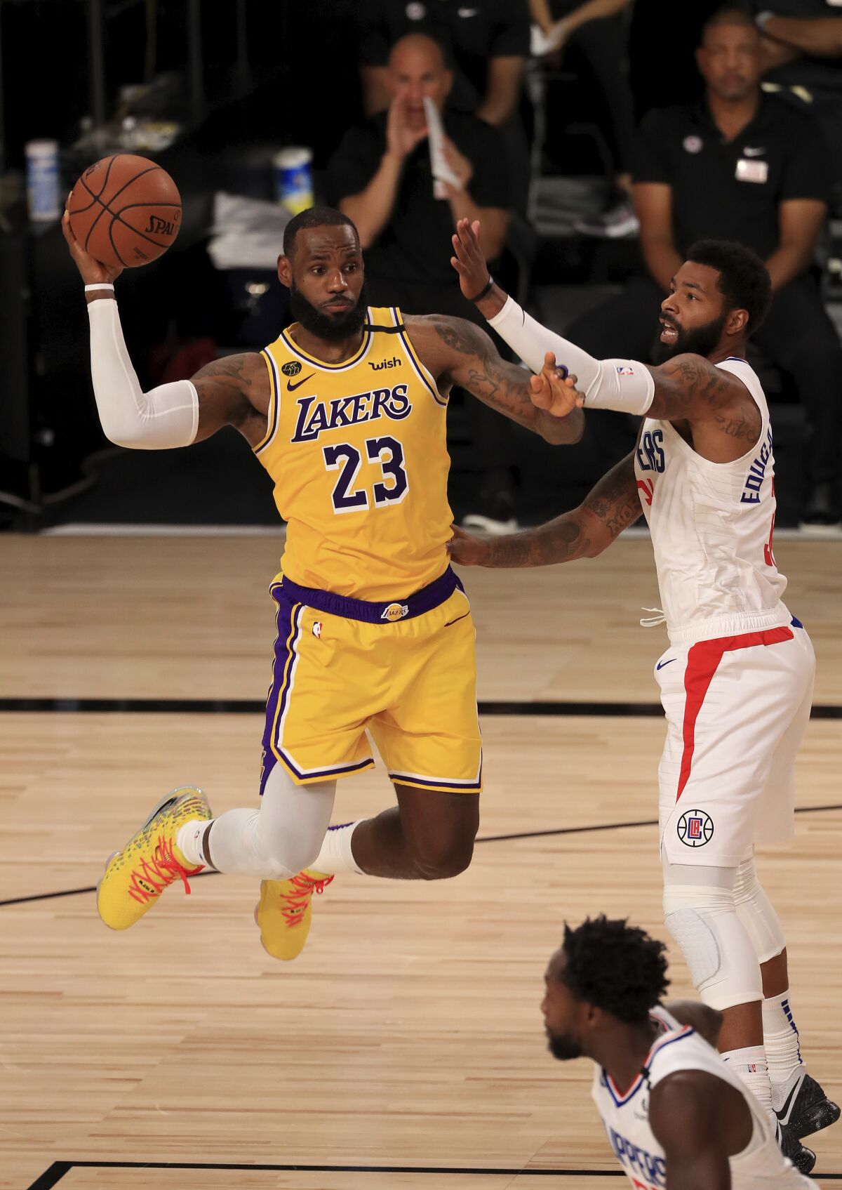 LeBron James looks to pass against the defense of Marcus Morris during the third quarter.