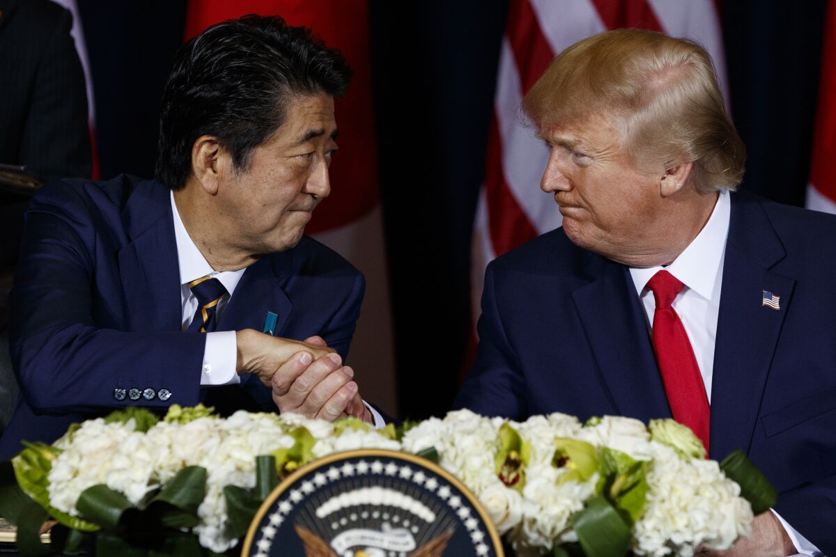 Then-Japanese Prime Minister Shinzo Abe shaking hands with then-President Trump