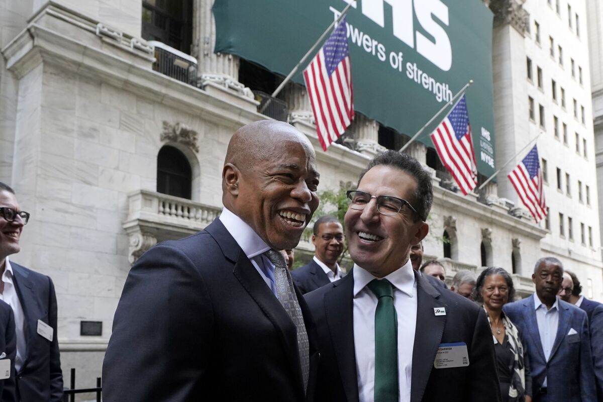 Democrat candidate for New York Mayor Eric Adams, left, poses for photos with IHS Towers Chairman & CEO Sam Darwish outside the New York Stock Exchange, before the company's IPO, Thursday, Oct. 14, 2021. (AP Photo/Richard Drew)