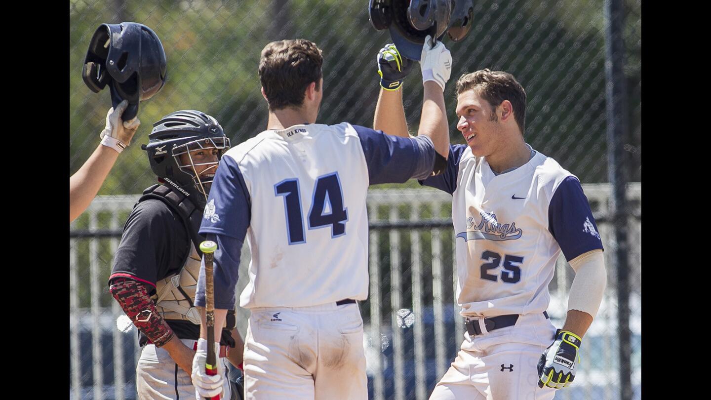 Corona del Mar's Preston Hartsell, right, gets high fives from his teammates after hitting a solo home run in the against Palm Springs in the Newport Rib Company Classic Tuesday, April 11.