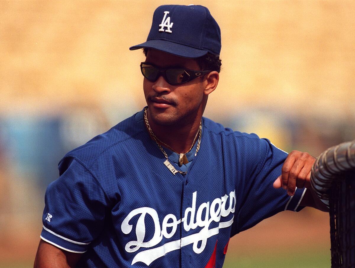 Dodgers' Raul Mondesi pauses at the batting cage at Dodger Stadium before a game