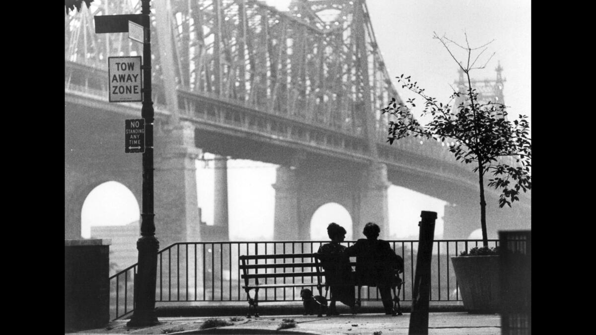 Diane Keaton and Woody Allen are silhouetted in the shadow of the Queensborough Bridge as they chat on a Sutton Place bench in the 1979 movie "Manhattan."