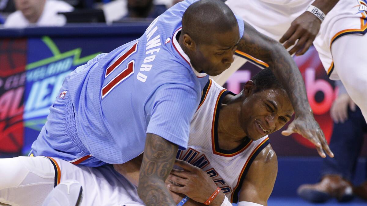 Clippers guard Jamal Crawford, left, and Oklahoma City Thunder guard Russell Westbrook battle for a loose ball during the Clippers' 131-108 loss on Feb. 8, 2015.