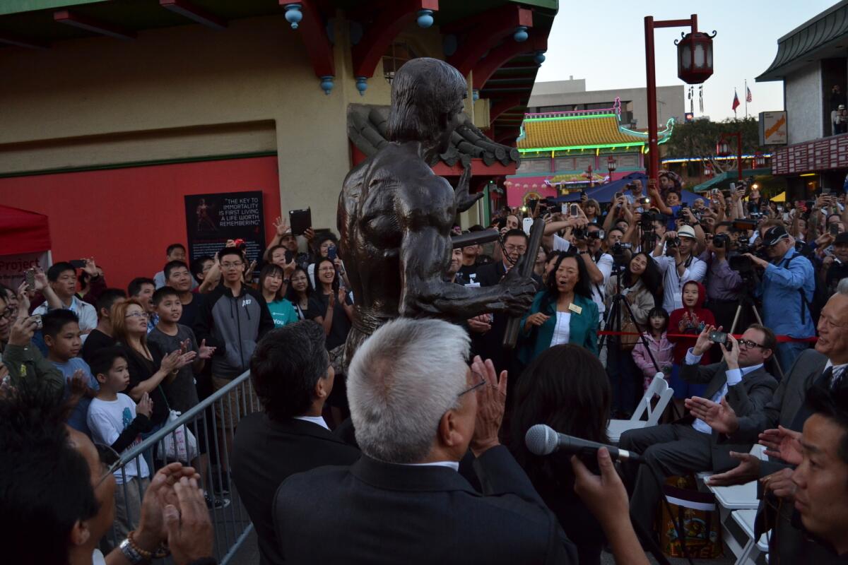 Several hundred people turned out for the unveiling of a Bruce Lee statue.