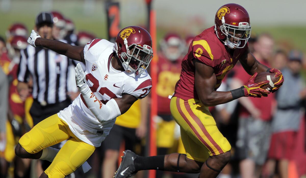 Trojans wide receiver JuJu Smith (9) cuts back across the field after a reception against safety Leon McQuay (22) during the annual spring game Saturday.