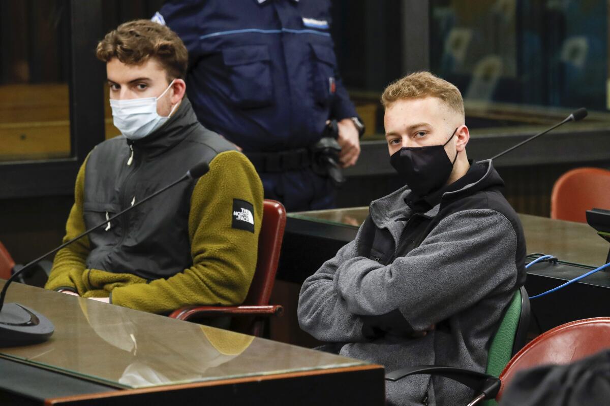 Gabriel Natale-Hjorth, from the United States, left, and his co-defendant Finnegan Lee Elder wear face masks to curb the spread of COVID-19 as they sit during a break of a hearing in the trial where they are facing murder charges after Italian Carabinieri paramilitary police officer Mario Cerciello Rega was fatally stabbed on a Rome street in July 2019, in Rome, Monday, April 26, 2021. (Remo Casilli/Pool Photo via AP)