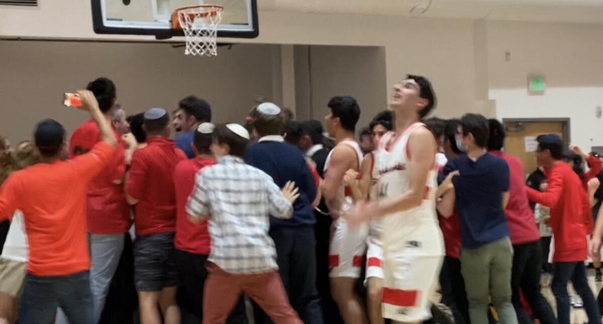 Shalhevet students and players celebrate after a 2021 basketball game.