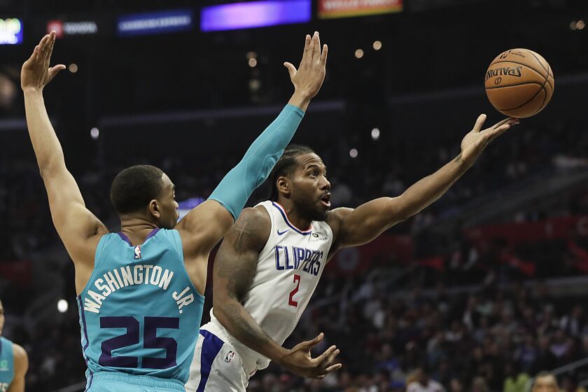 LOS ANGELES, CA, MONDAY, OCTOBER 28, 2019 - LA Clippers forward Kawhi Leonard (2) scoops a shot past Charlotte Hornets forward PJ Washington (25) during second half action at Staples Center.(Robert Gauthier/Los Angeles Times)