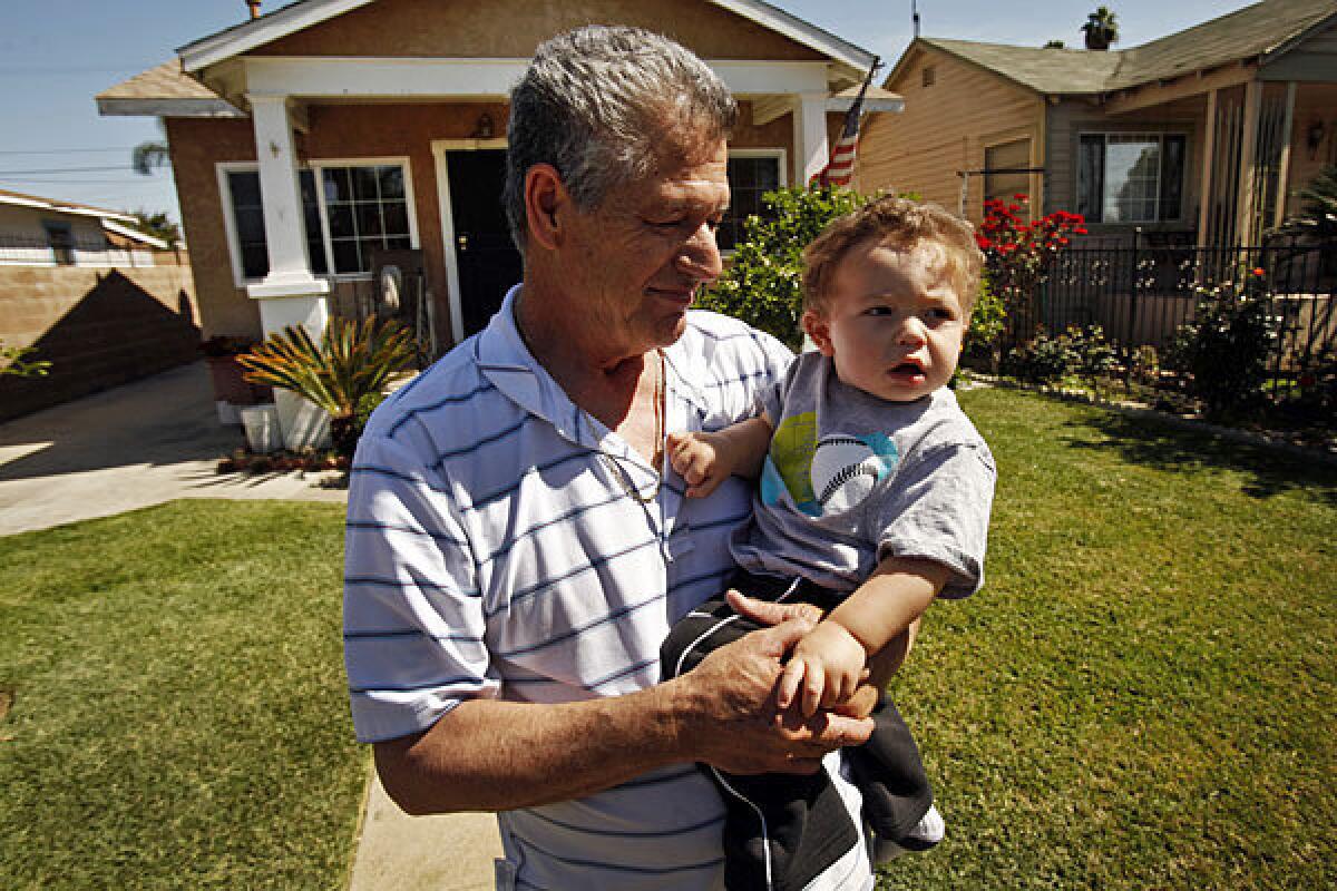 Jose Luis Jimenez, holding his grandson Jason Jimenez, is a resident of the neighborhood where elevated levels of lead were found.