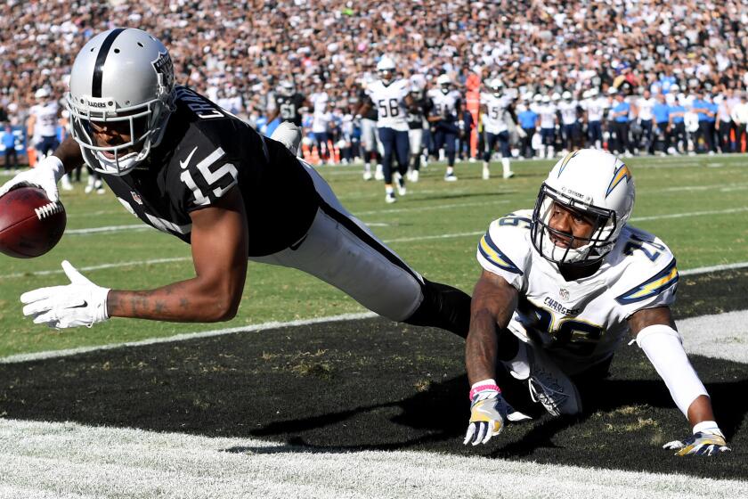 Raiders receiver Michael Crabtree scores on a 21-yard pass against Chargers cornerback Casey Hayward.