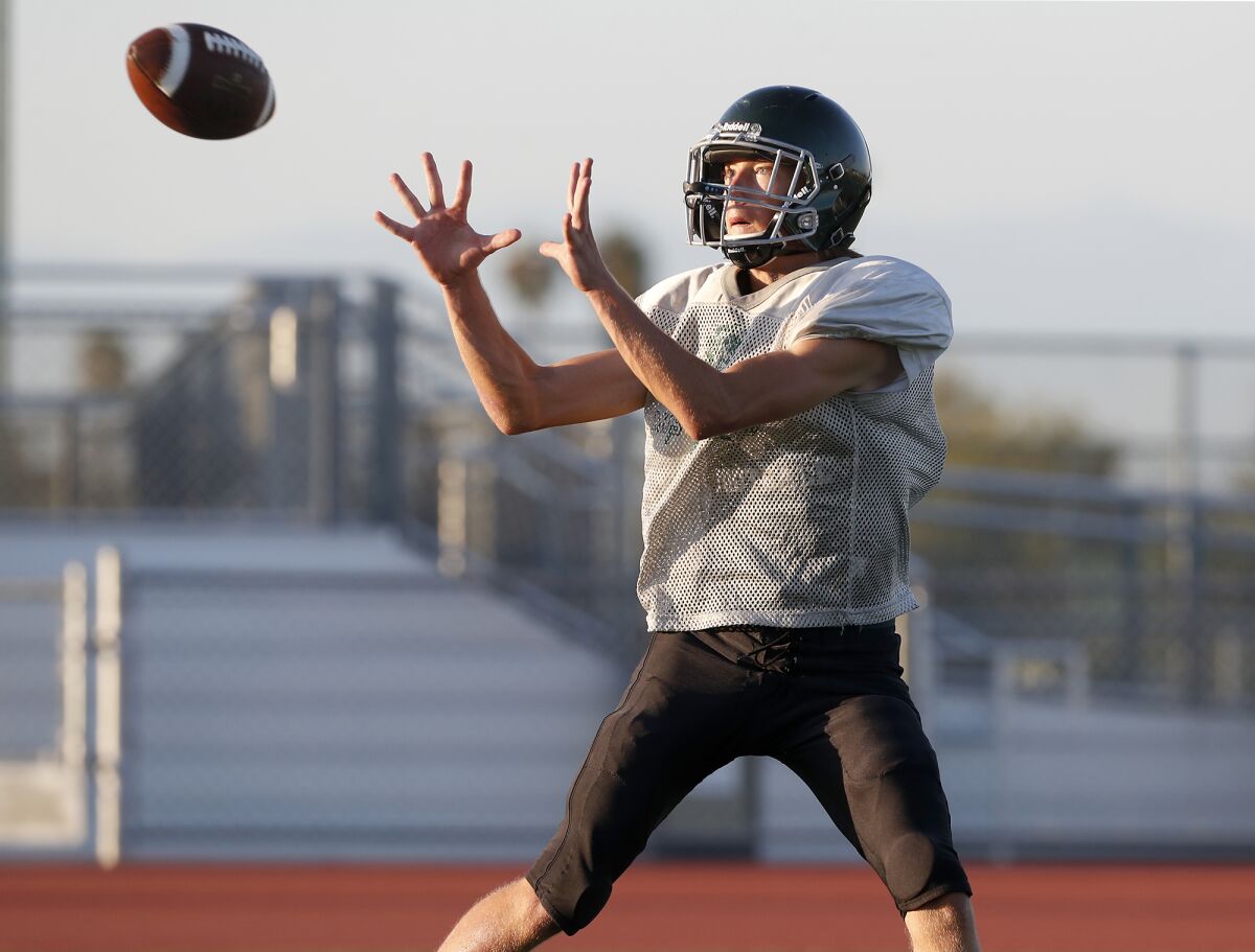 Costa Mesa wide receiver Cory Richards goes up for a pass in a practice on Monday.