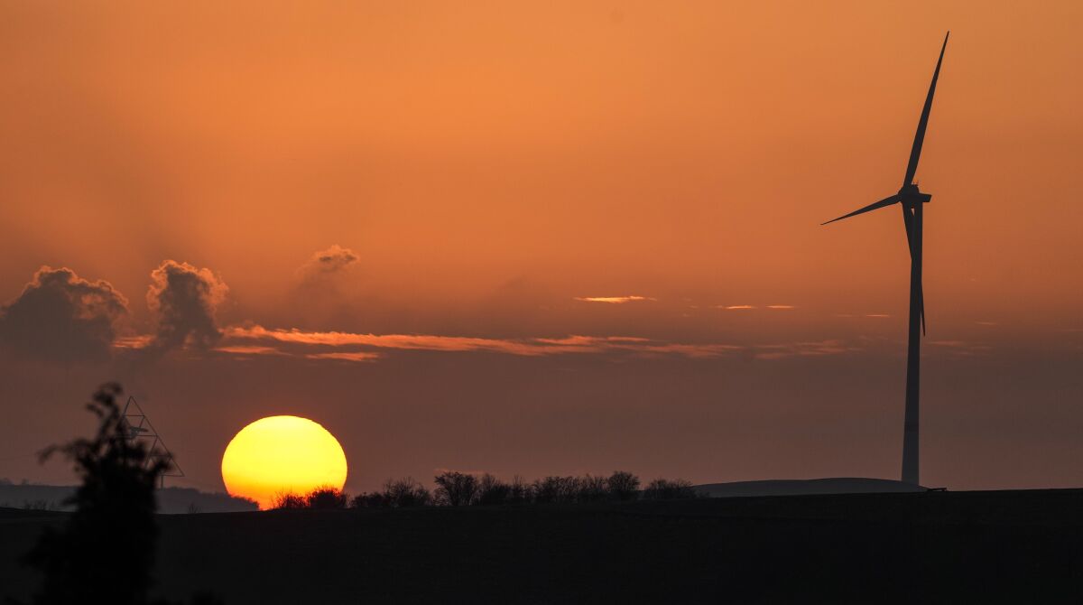 A wind turbine at sunset in Gelsenkirchen, Germany, Monday, Jan. 10, 2022. (AP Photo/Martin Meissner)
