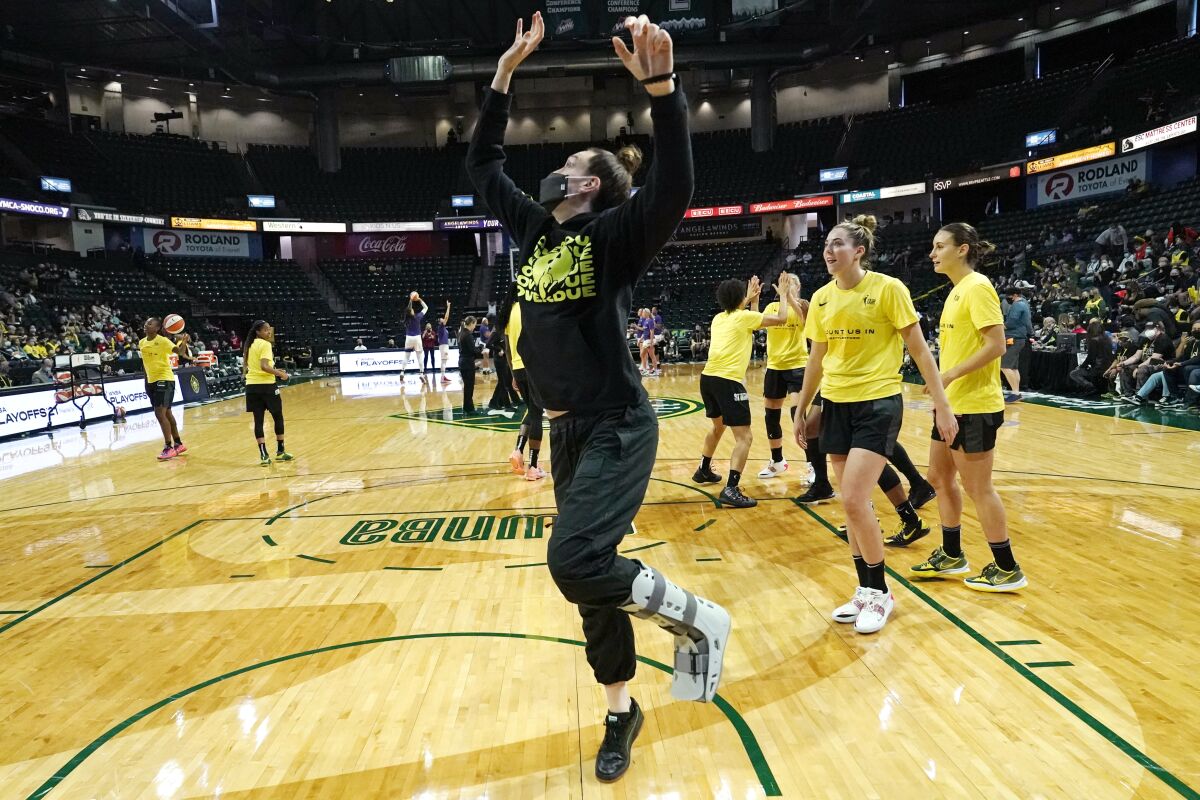 Seattle Storm's Breanna Stewart playfully takes a one-footed jump with teammates warming-up before a second round game against the Phoenix Mercury in the WNBA basketball playoffs Sunday, Sept. 26, 2021, in Everett, Wash. Stewart did not play because of her injury. (AP Photo/Elaine Thompson)