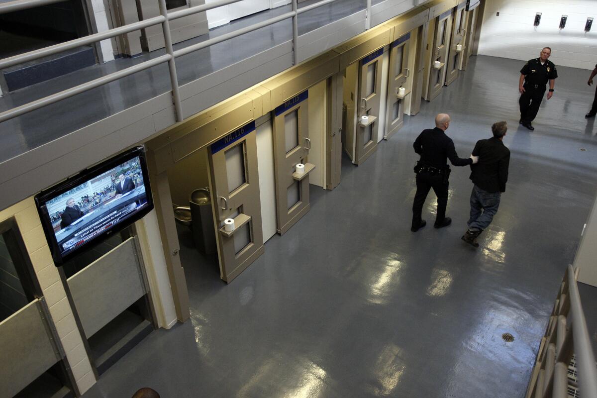 A prisoner is taken to his cell at the Metropolitan Detention Center in downtown Los Angeles.