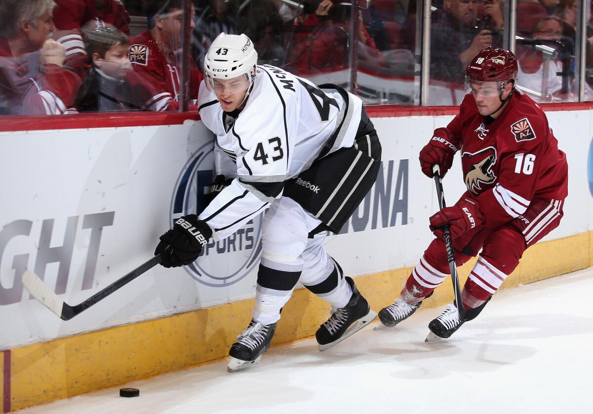 The Kings' Brayden McNabb attempts to control the puck ahead of Arizona's Max Domi on Sept. 22.