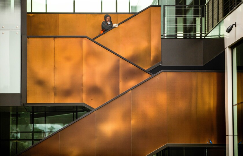 This photo shows a worker cleaning a staircase railing.