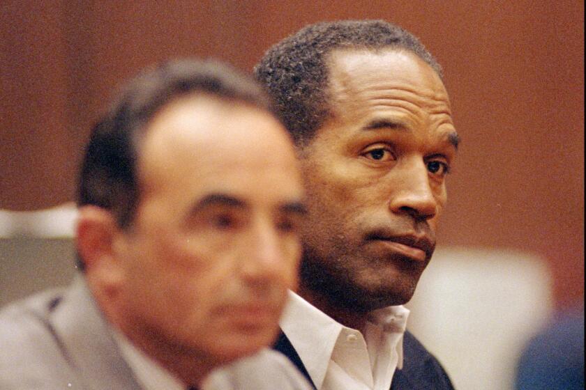 O.J. Simpson, right, sits with his lead defense attorney Robert L. Shapiro during a hearing in a Los Angeles courtroom on June 28, 1994. FX's "American Crime Story" has explored the trial.