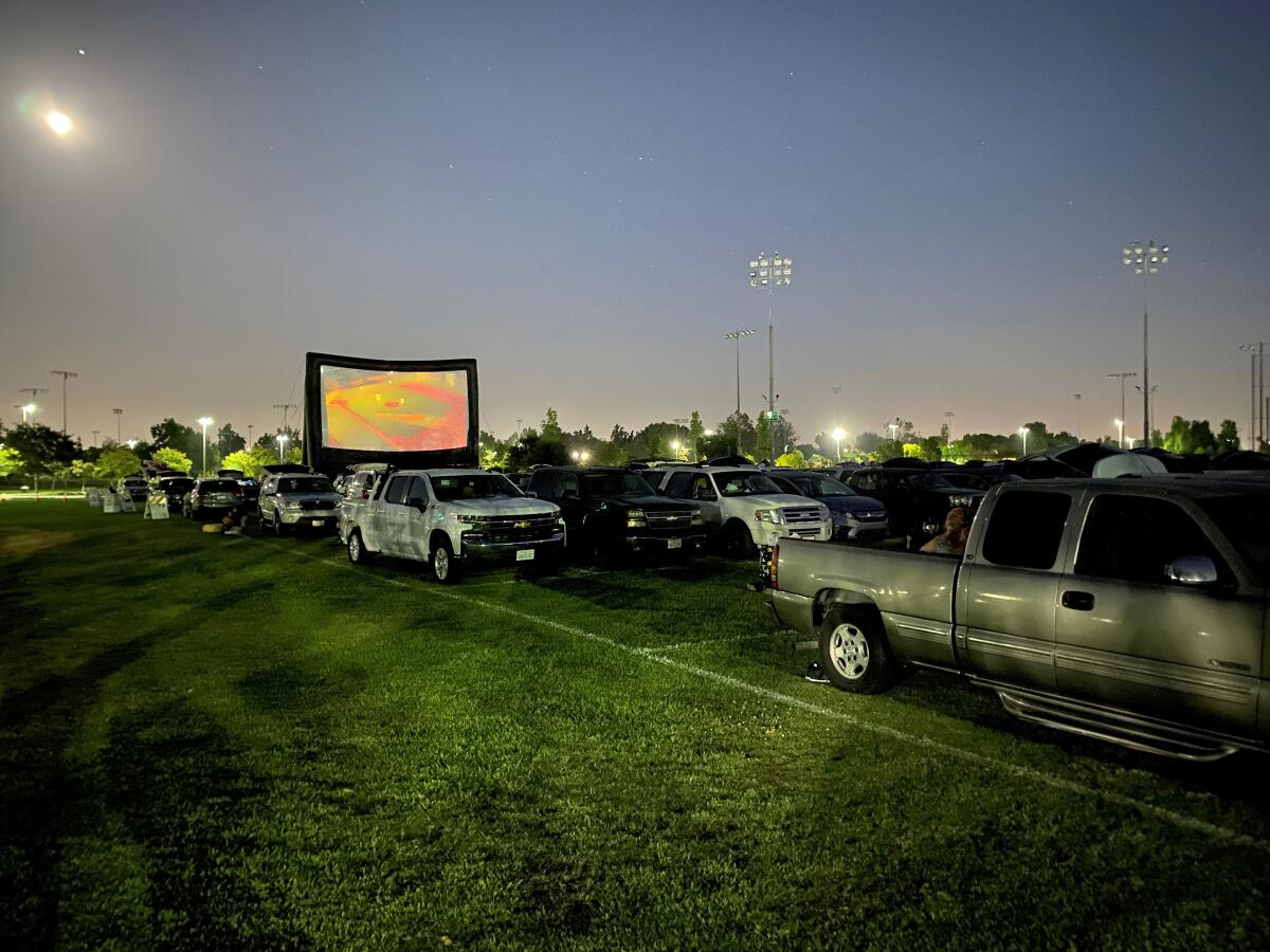 Cars park on the grass at Mile Square Park in Fountain Valley to watch a drive-in showing of "Sonic the Hedgehog" on Aug. 1.