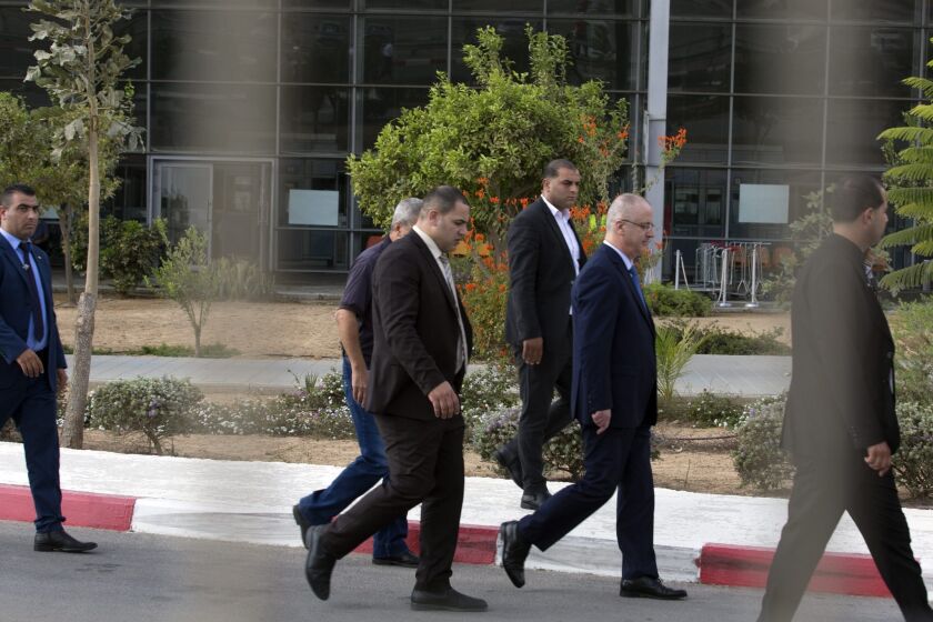 Palestinian Authority Prime Minister Rami Hamdallah, second from right, and security agents pass the Erez crossing terminal after organizing passage into the Gaza Strip on Oct. 9.