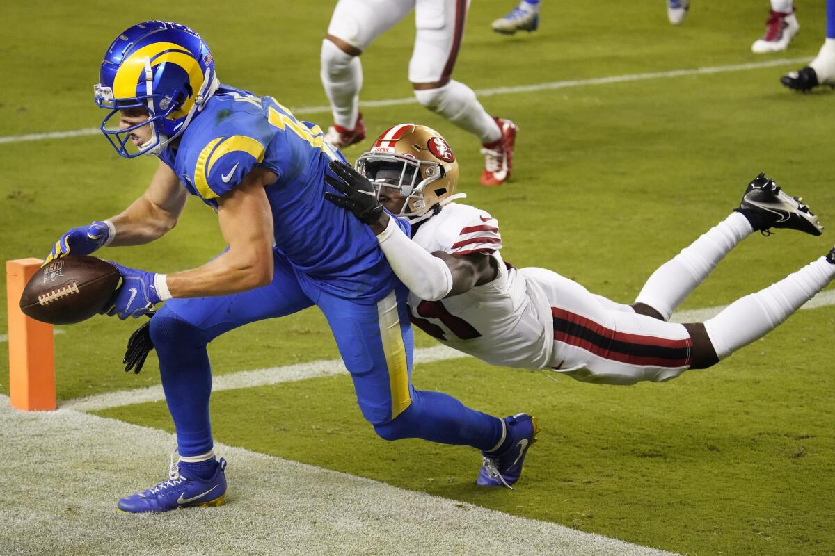 The Rams' Cooper Kupp drops a potential touchdown pass a  49ers' Emmanuel Moseley defends.