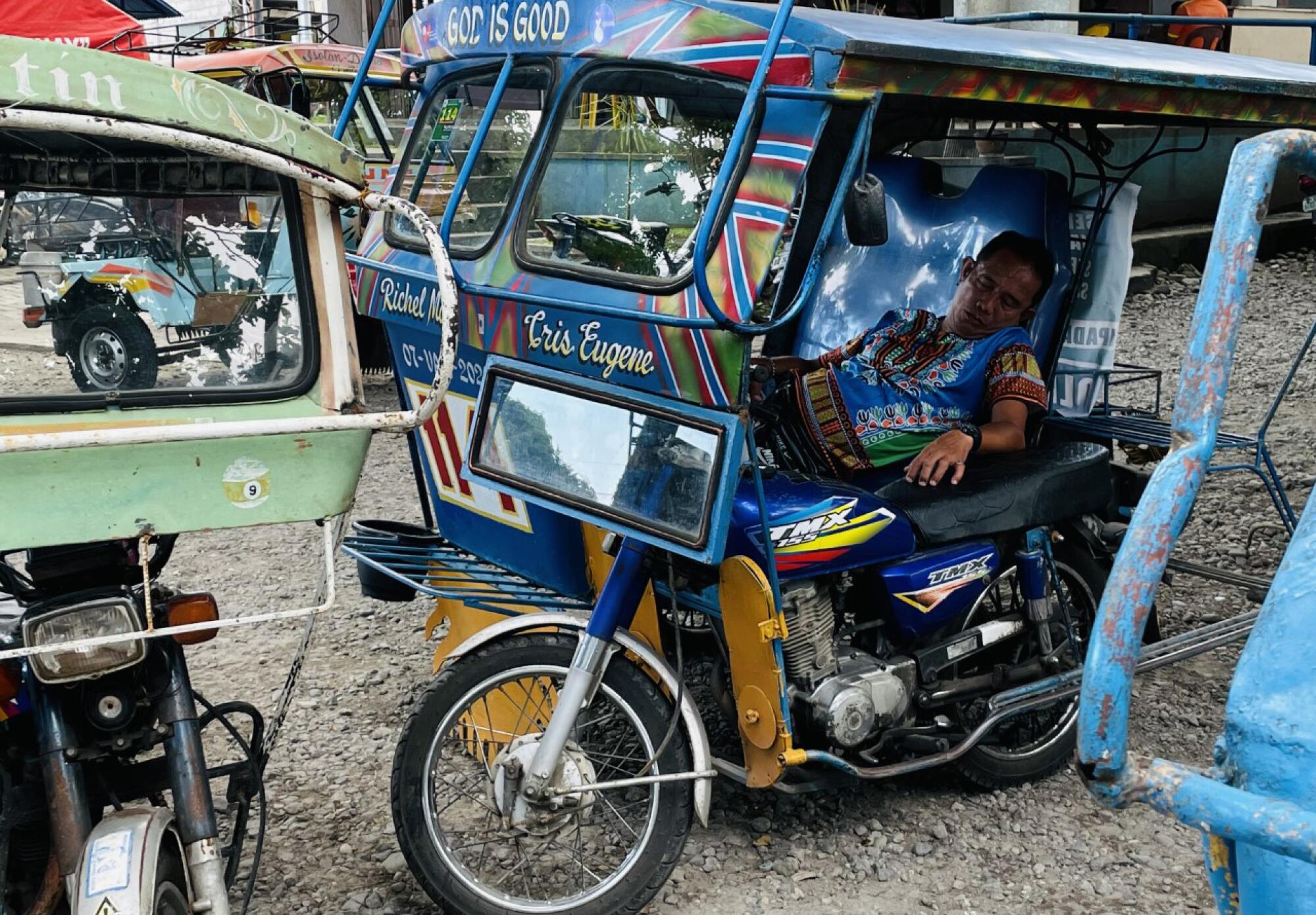 A napping pedicab driver in Manila.