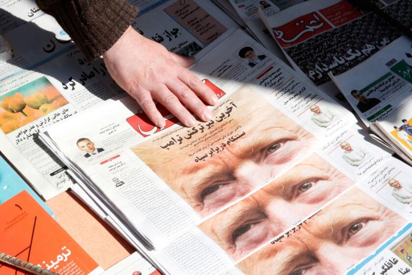 Mandatory Credit: Photo by ABEDIN TAHERKENAREH/EPA-EFE/REX (10195419b) An Iranian man adjusts copies of the Iranian daily newspapers 'Shargh' with a picture of US President Donald Trump on its front page and the title reading in Persian 'The last bullet of Trump', in front of his kiosk in Tehran, Iran, 09 April 2019. The US government on 08 April 2019 said it had designated Iran's revolutionary guards corps (IRGC) as a terrorist organization, marking the first time a US government has made such a designation on a foreign government's organization. US designates Iran's Revolutionary Guards a terrorist organization, Tehran, Iran (Islamic Republic Of) - 09 Apr 2019 ** Usable by LA, CT and MoD ONLY **