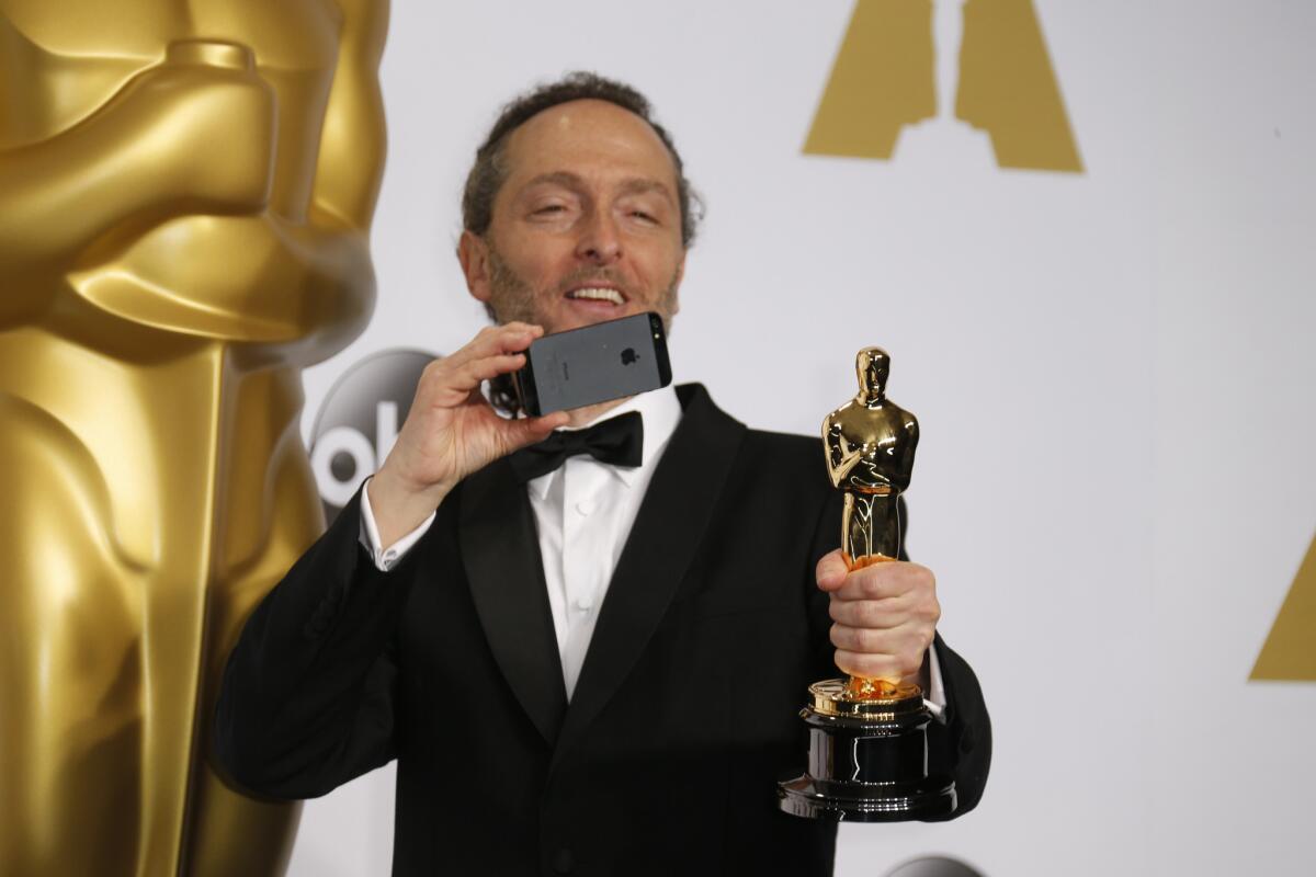 Lubezki, who won the cinematography award for "Birdman," photographs his Oscar. It's his second Academy Award.