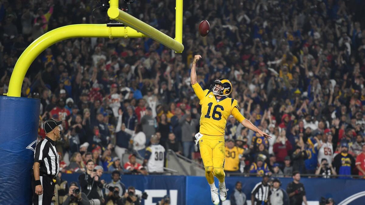 Quarterback Jared Goff of the Rams celebrates his seven-yard rushing touchdown by laying up the football between the goal posts during the third quarter against the Kansas City Chiefs at the Coliseum on November 19, 2018.