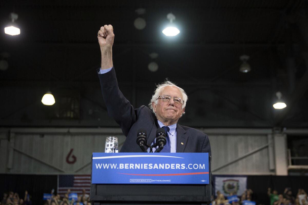 Sen. Bernie Sanders raises his fist to acknowledge the crowd before he speaks during a campaign event at the Big Sandy Superstore Arena on April 26, 2016, in Huntington, W.Va.