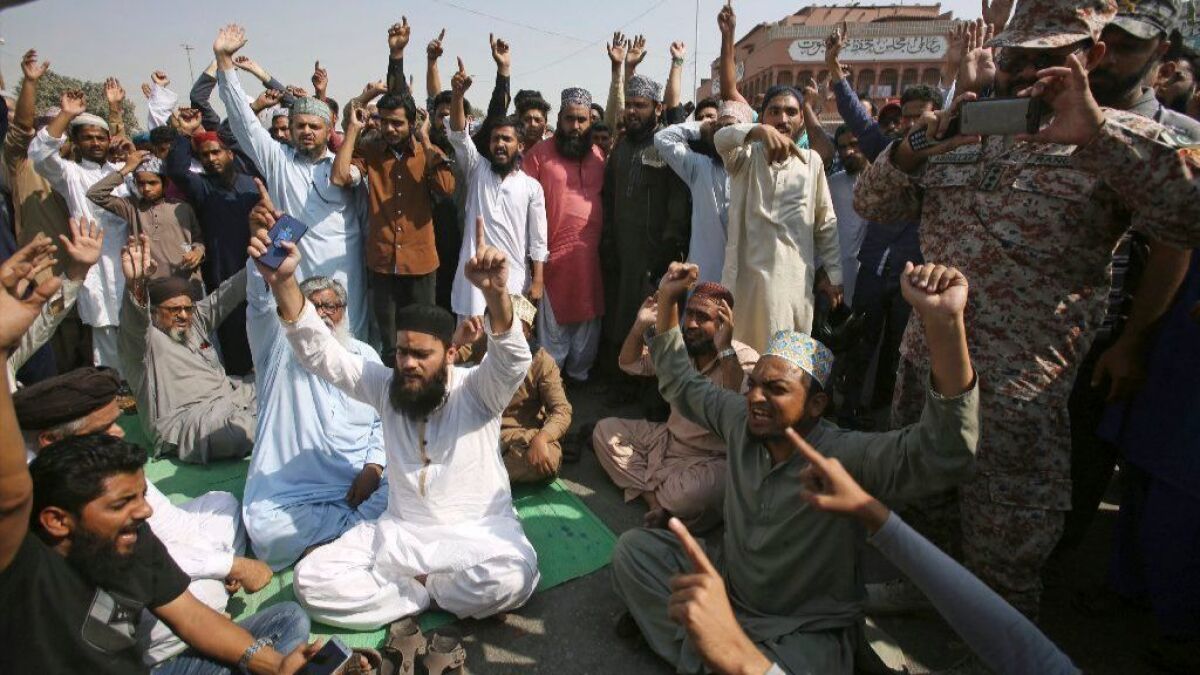 Supporters of a Pakistani religious group chant slogans in Karachi, Pakistan, after the Supreme Court overturned a conviction in a high-profile blasphemy case.