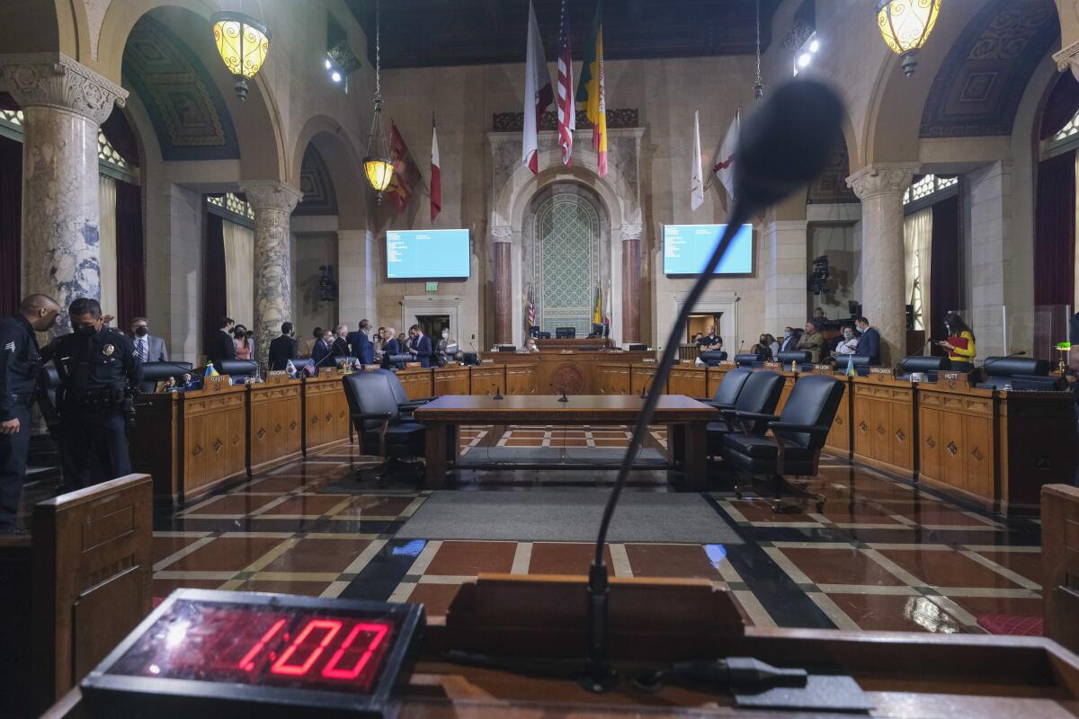 Los Angeles City Council members wait to start a meeting.