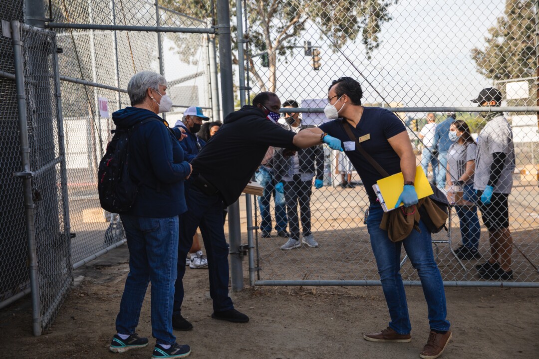 A veteran greets a volunteer escort at the annual “Stand Down” event.