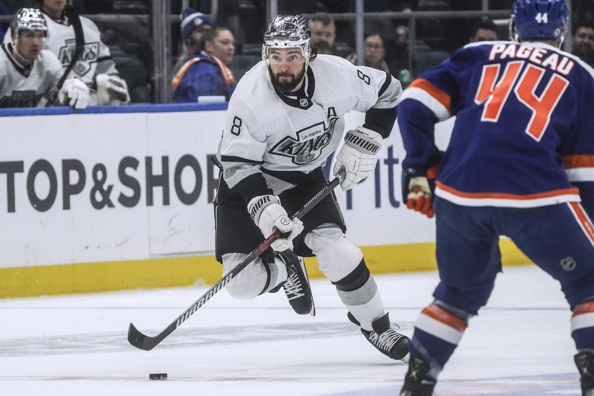 Kings defenseman Drew Doughty, left, controls the puck during a 3-2 loss to the New York Islanders on Saturday night.