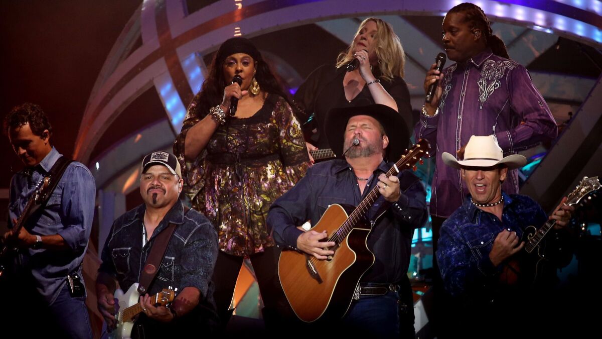 Garth Brooks, surrounded Saturday by members of his band, led a three-hour marathon show at the Forum in Inglewood, the last of four concerts at the arena on his 2017 world tour.