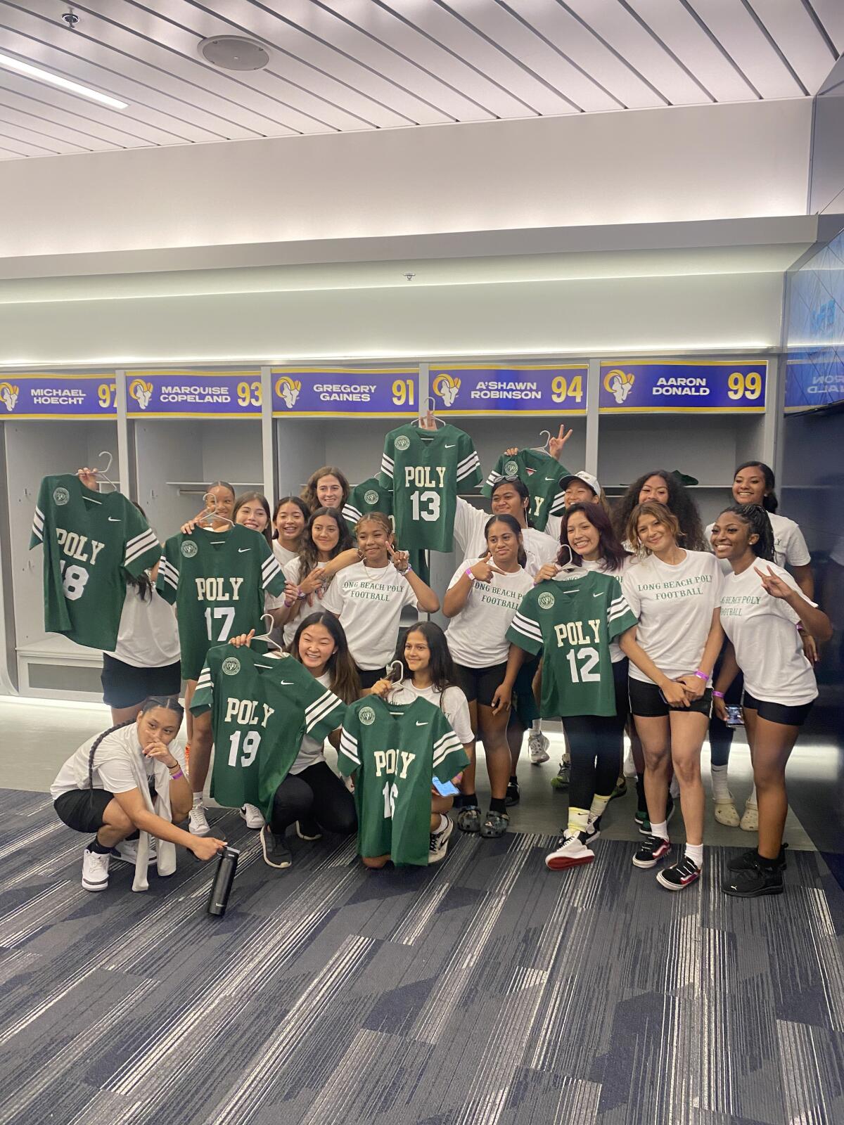 Members of the Long Beach Poly team in the League of Champions girls' flag football league receive their jerseys.