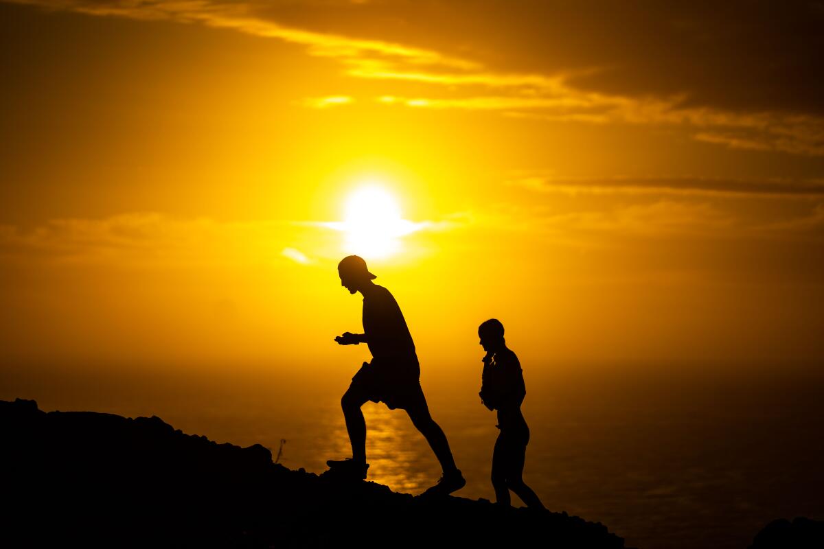 People walk the Makapuu Point Lighthouse Trail on the eastern shore of the island of Oahu.