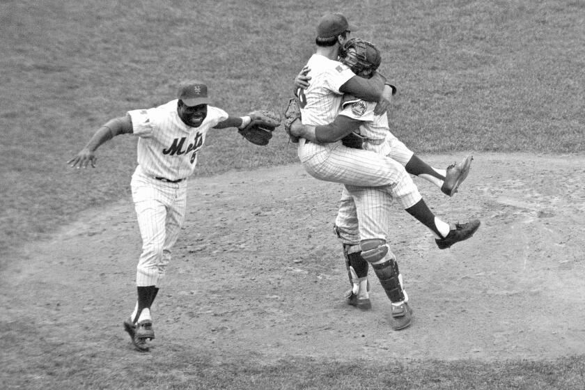 FILE - In this Oct. 16, 1969 file photo, New York Mets catcher Jerry Grote, right, embraces pitcher Jerry Koosman as Ed Charles, left, joins the celebration after the Mets defeated the Baltimore Orioles in the Game 5 to win the baseball World Series at New York's Shea Stadium. Grote, the catcher who helped transform the New York Mets from a perennial loser into the 1969 World Series champion, died Sunday, April 7, 2024. (AP Photo, File)