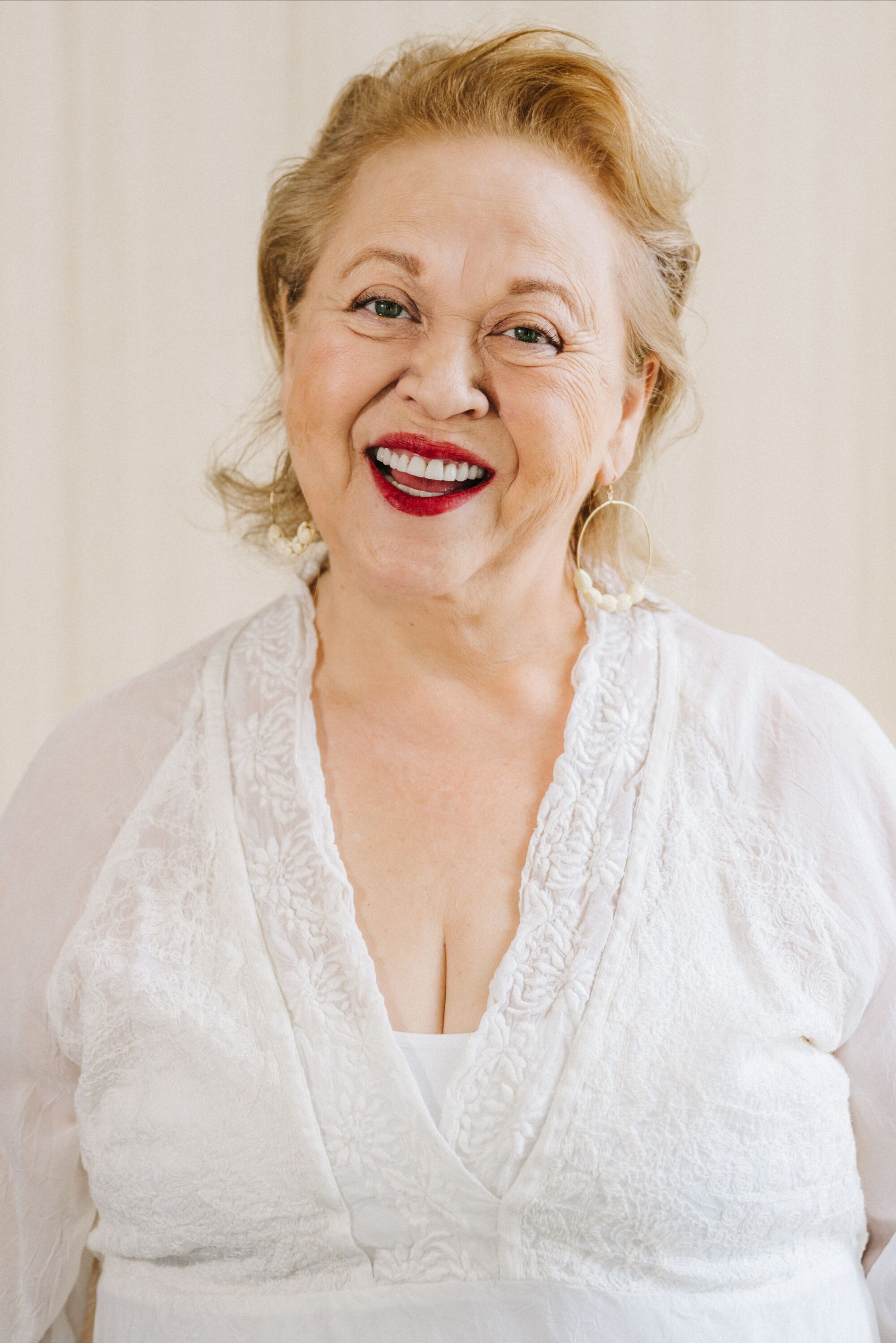 A woman smiles at the camera.