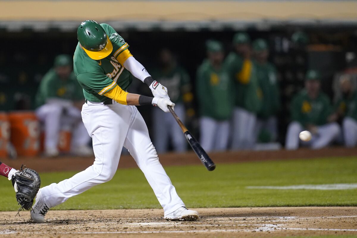 Oakland Athletics' Yan Gomes hits an RBI single against the Chicago White Sox during the fourth inning of a baseball game in Oakland, Calif., Wednesday, Sept. 8, 2021. (AP Photo/Jeff Chiu)