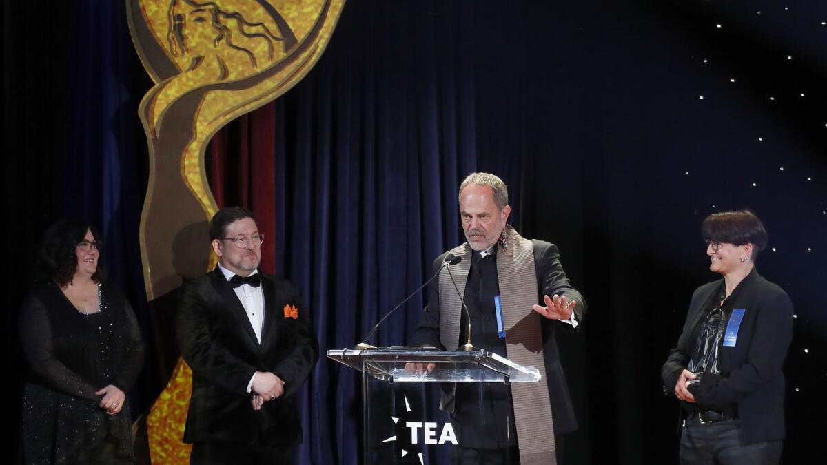 Disney Imagineers Joe Rohde, second from right, and Amy Jupiter, right, accept a Thea Award.