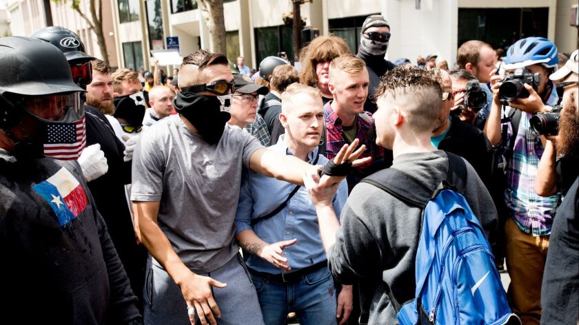 Identity Evropa founder Nathan Damigo, in a blue shirt at center, faces off with counterprotesters during a conservative rally in Berkeley in April 2017.