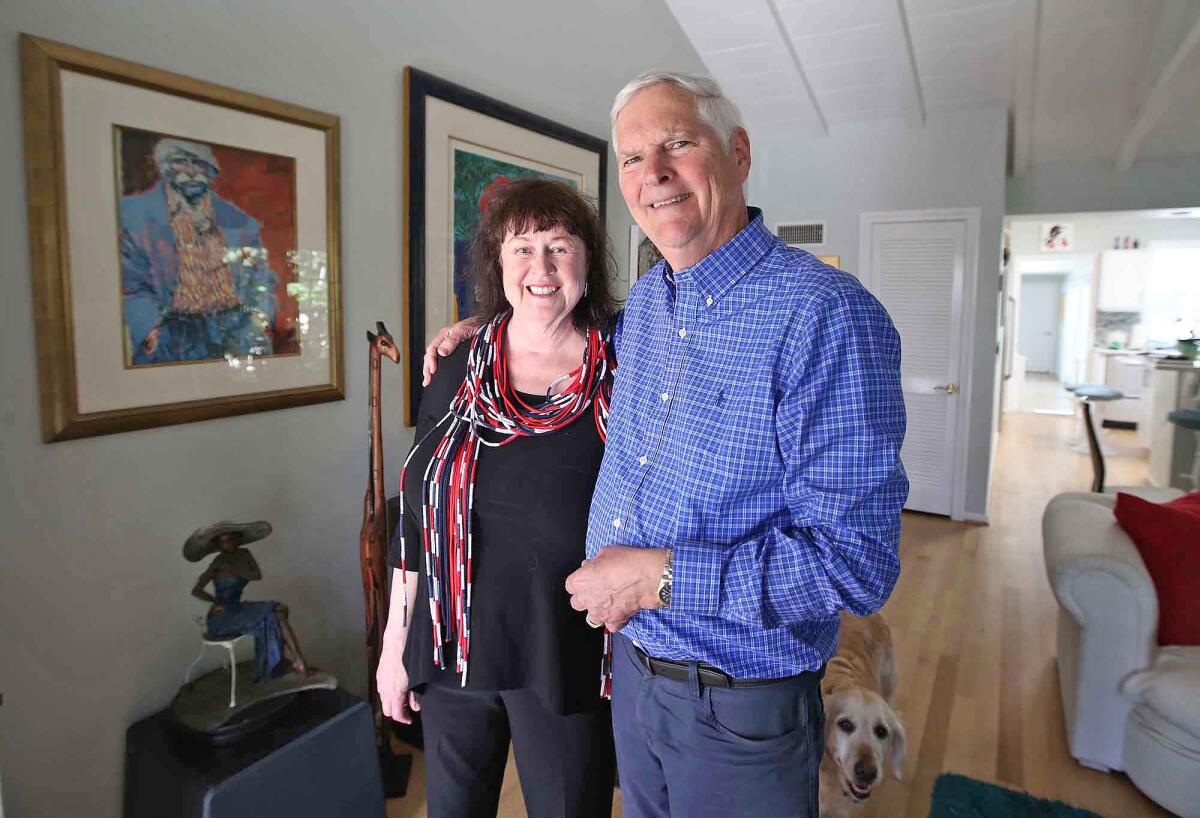 Jim Gray, right, and his wife, Dr. Grace Walker Gray, at their Newport Beach home.