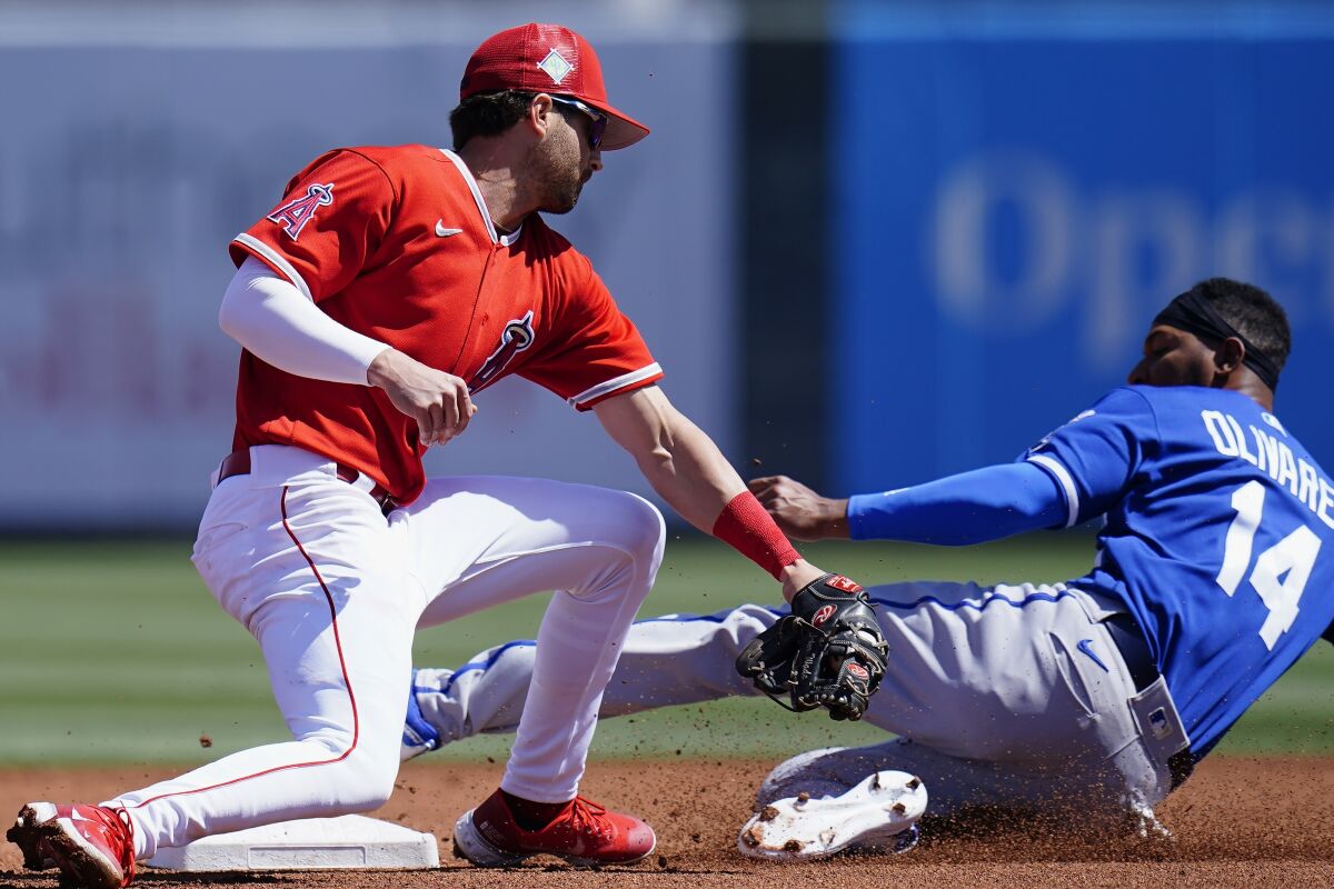 Kansas City's Edward Oliveras, right, beats the tag of the Angels' Tyler Wade during a spring training game.