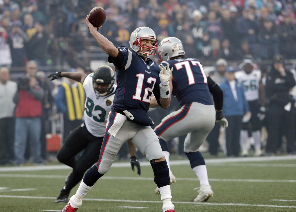 New England Patriots quarterback Tom Brady throws a pass under pressure from Jacksonville Jaguars defensive end Calais Campbell (93) during the first half of the AFC championship NFL football game, Sunday, Jan. 21, 2018, in Foxborough, Mass.